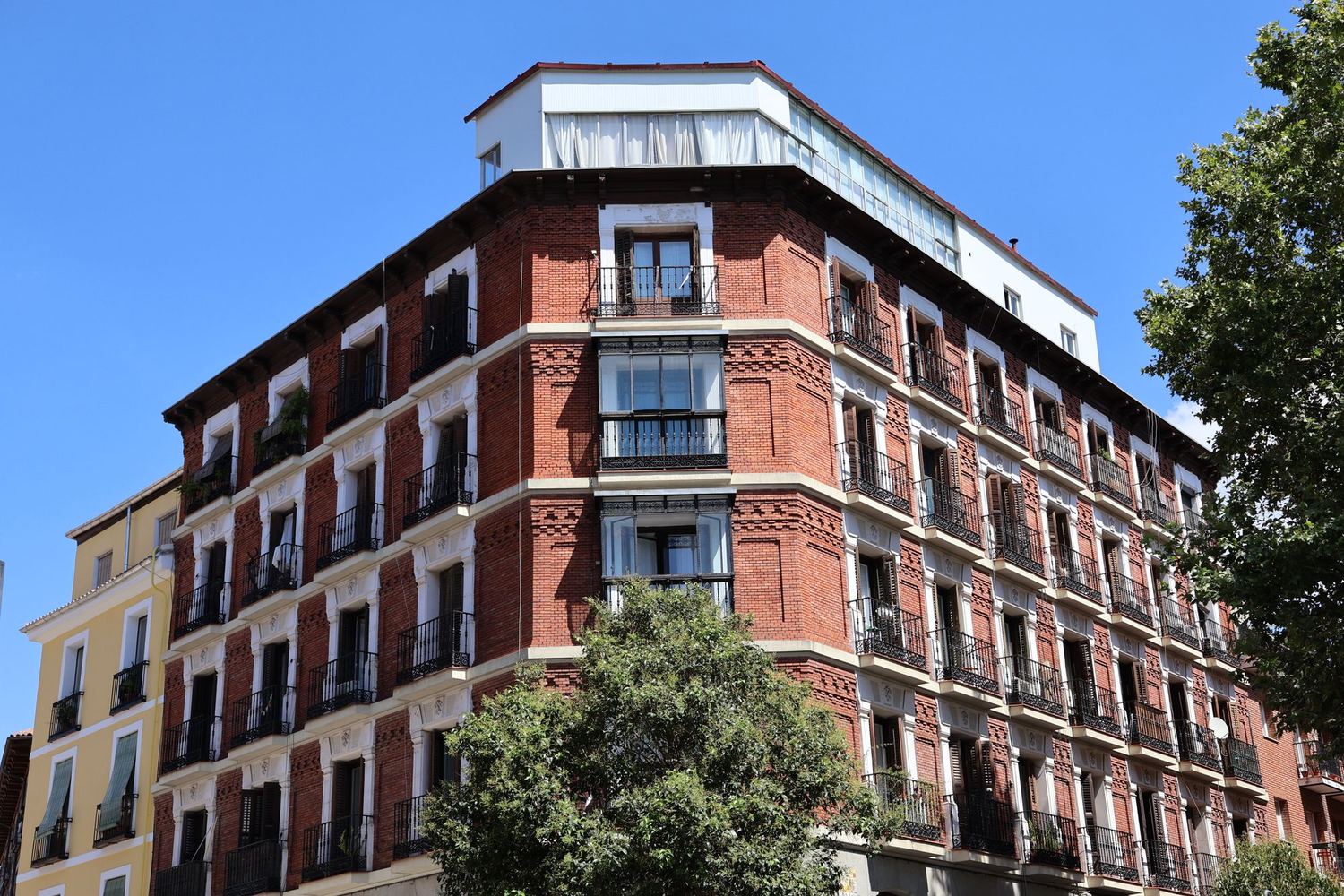 Edificio de viviendas de ladrillo con balcones de forja en Madrid